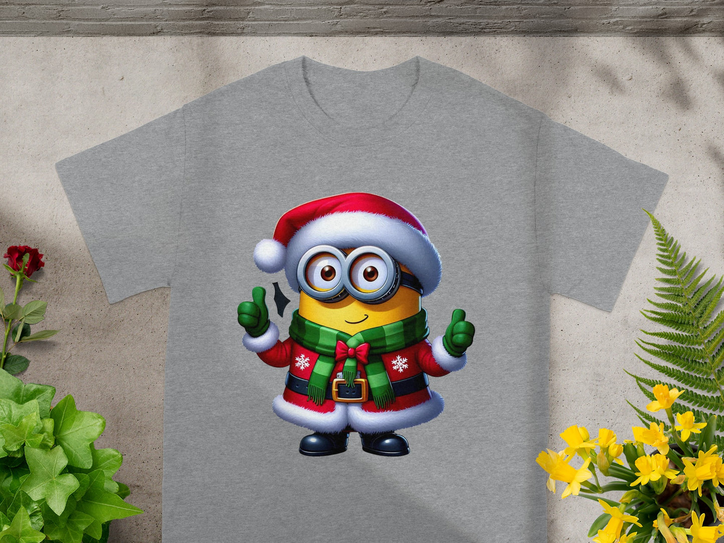 Minion in Christmas attire with festive scarf and Santa hat, giving thumbs up.