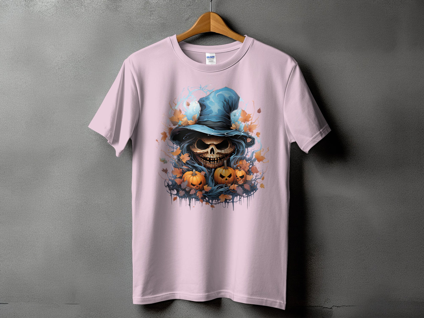 Pink t-shirt with a Halloween skull wearing a blue hat and pumpkins.