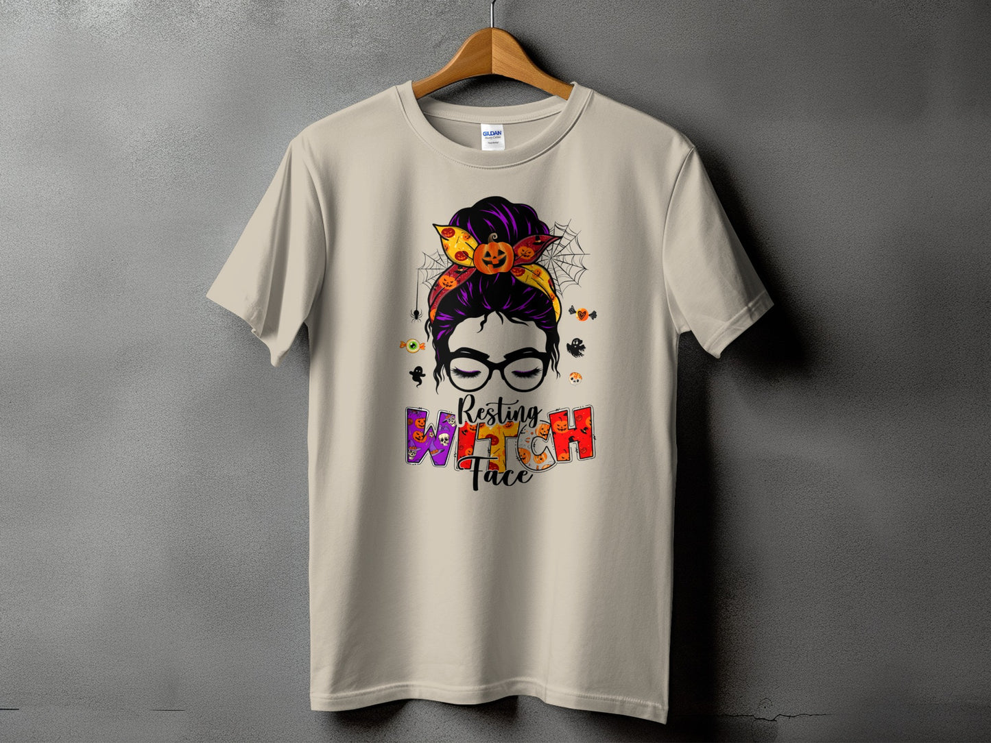 T-shirt with "Resting Witch Face" Halloween graphic featuring a messy bun and pumpkins.