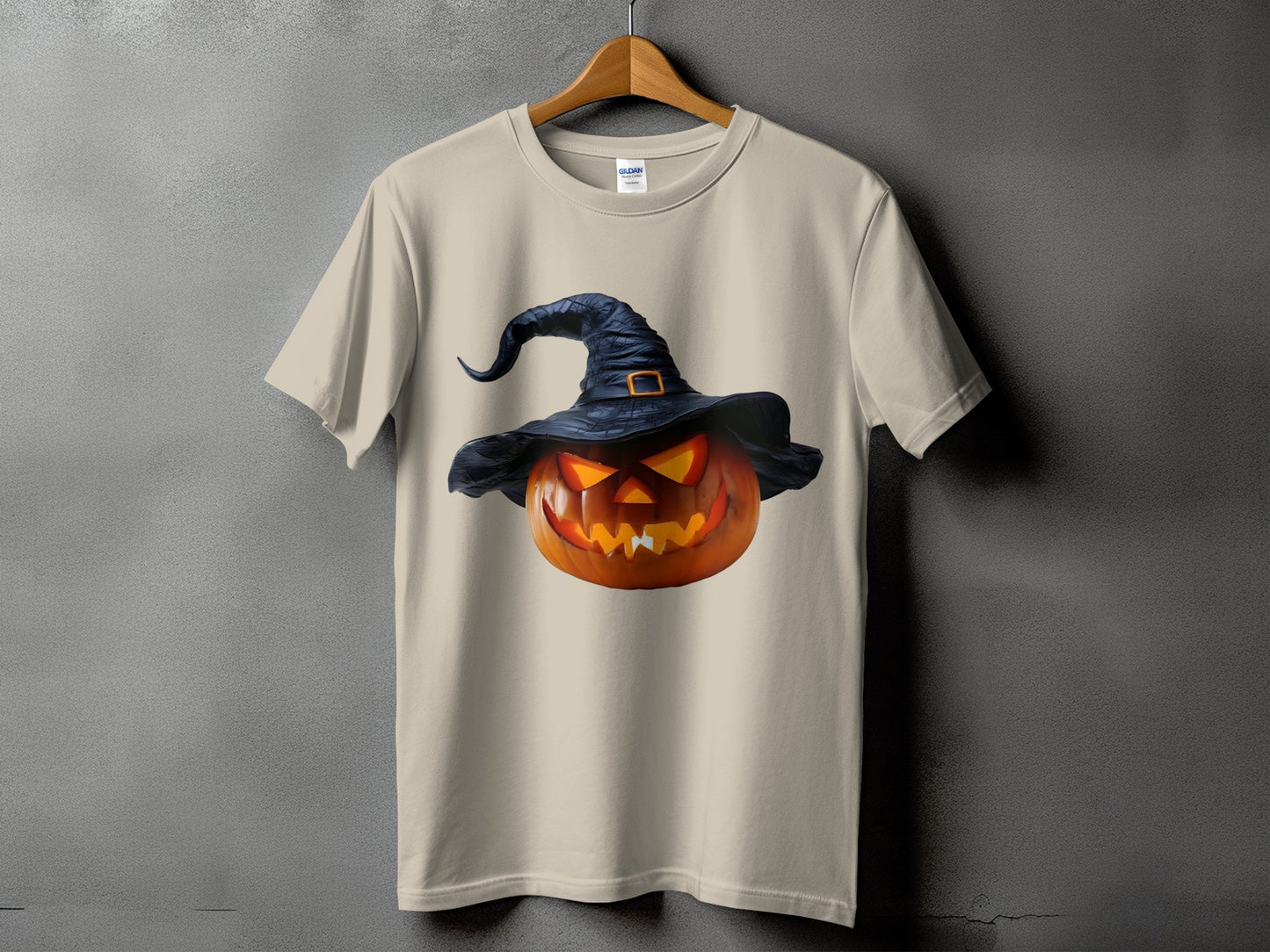 Light beige t-shirt with a grinning jack-o'-lantern wearing a black witch hat.