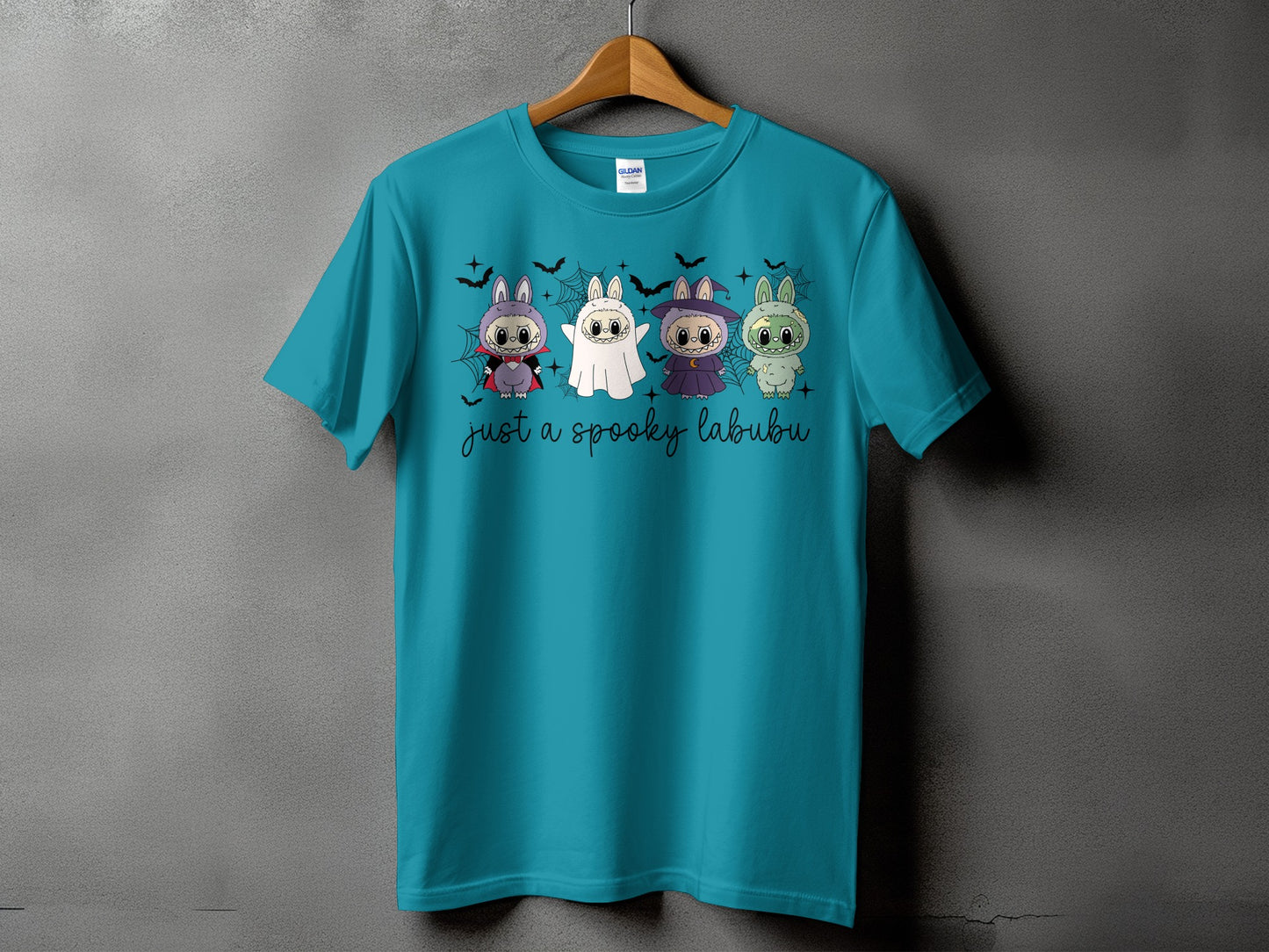 Teal t-shirt with four spooky Labubu characters and "just a spooky labubu" text.