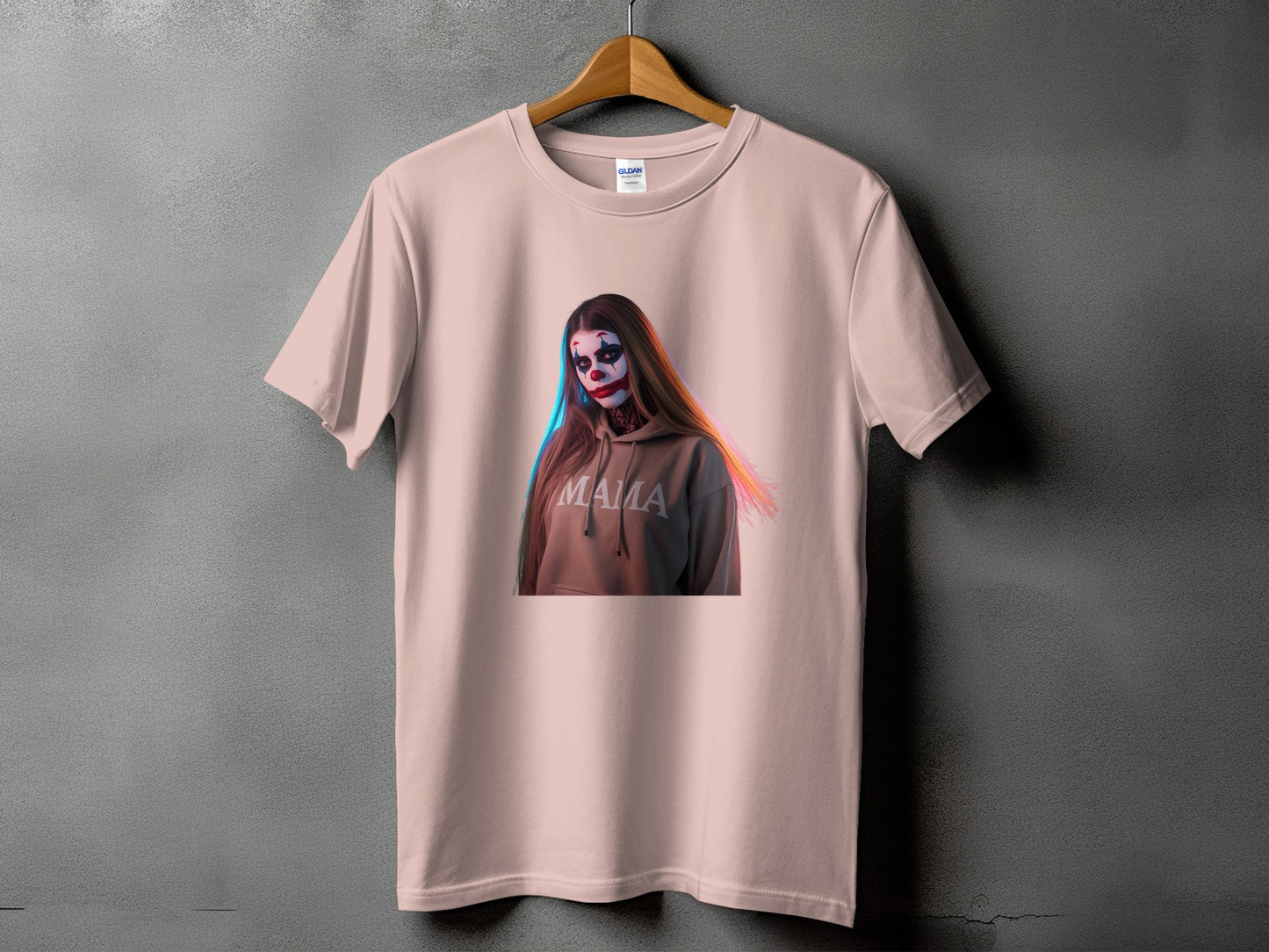 Pink t-shirt featuring a graphic of a person with clown makeup and the word "MAMA" on a hoodie.