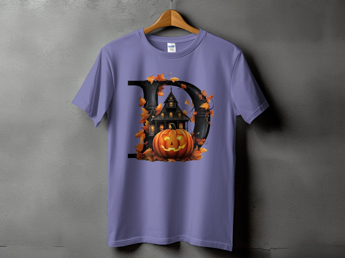 Purple t-shirt with a black letter D design featuring a haunted house and jack-o'-lantern.