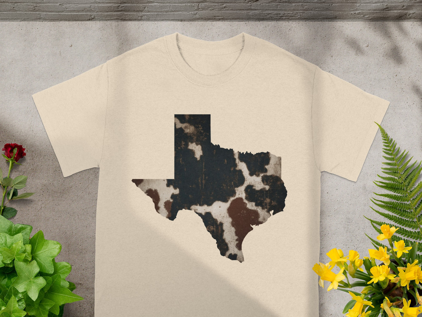 Cream t-shirt with a distressed cowhide pattern of Texas outline.