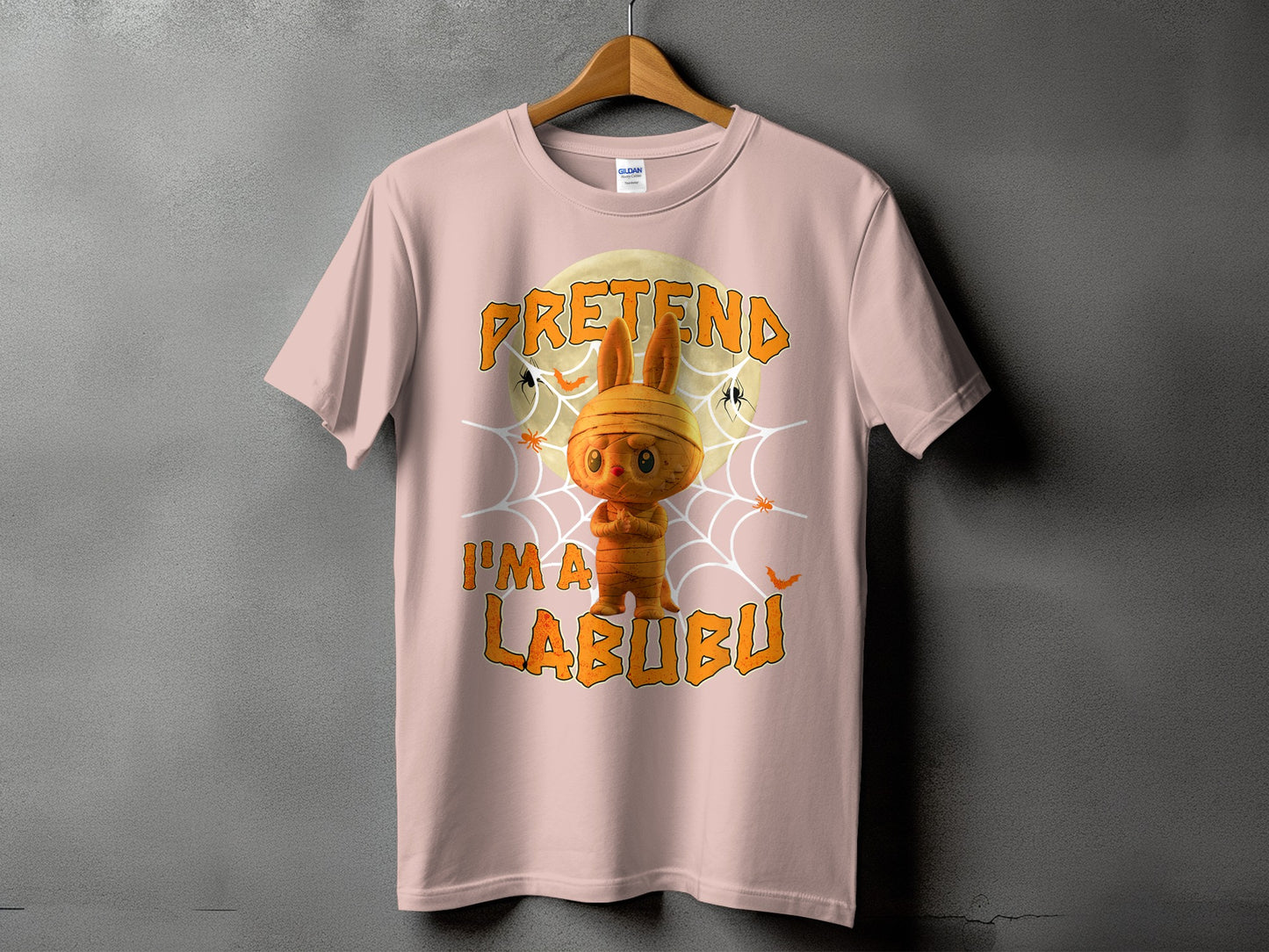 Pink t-shirt with a mummy bunny graphic and text "Pretend I'm a Labubu".
