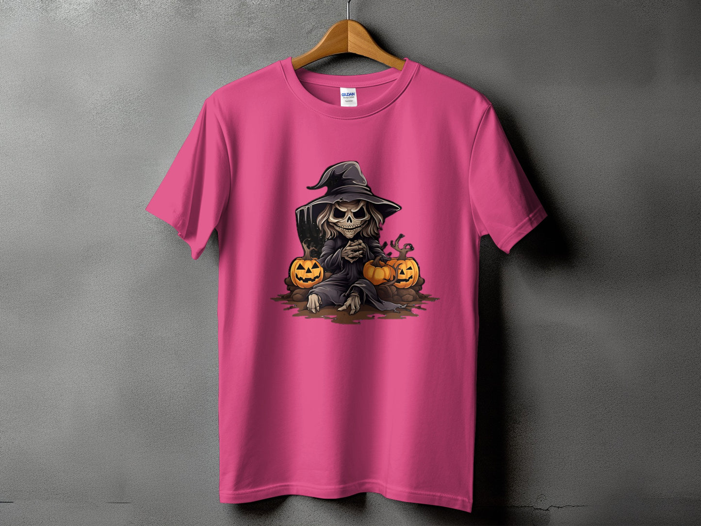 Pink t-shirt with a cartoon grim reaper and pumpkins Halloween graphic.