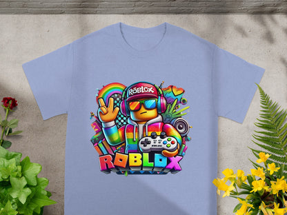Roblox character in colorful graphic tee and headphones holds controller.