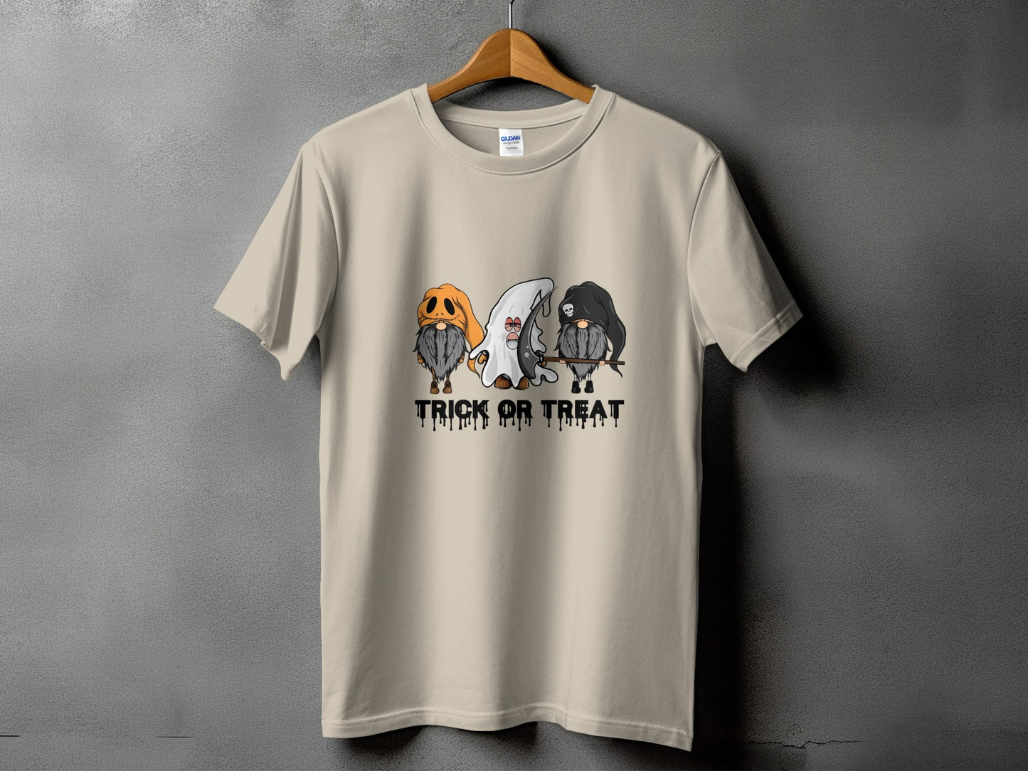 Beige t-shirt with three gnomes dressed for Halloween and "Trick Or Treat" text.