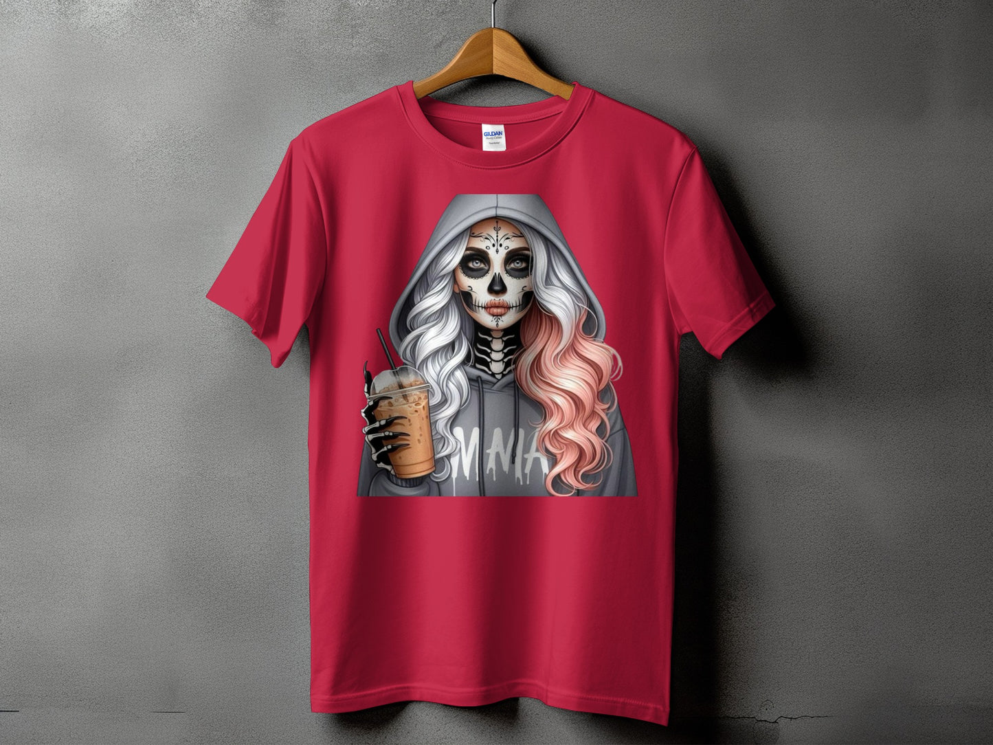 Skull-faced woman in a grey hoodie holding a coffee drink, graphic on a red t-shirt.