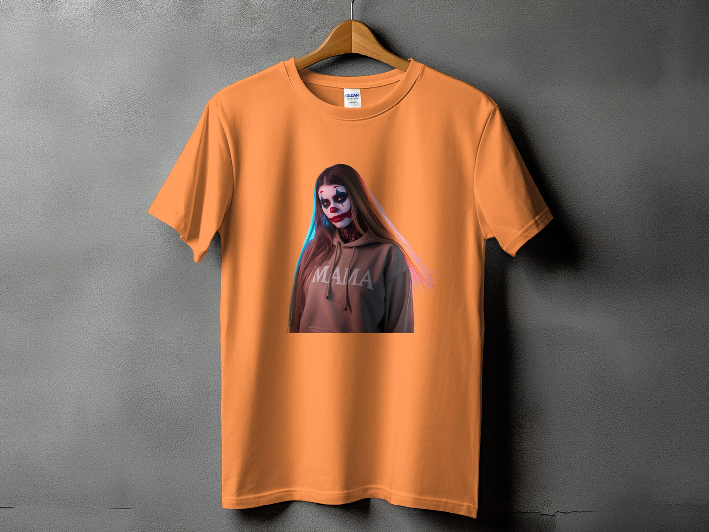 Orange t-shirt with a graphic of a woman in clown makeup wearing a hoodie that says "MAMA".