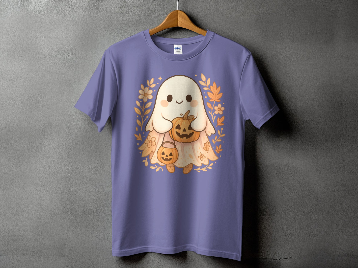 Purple t-shirt with a cute ghost holding a pumpkin, surrounded by fall leaves.