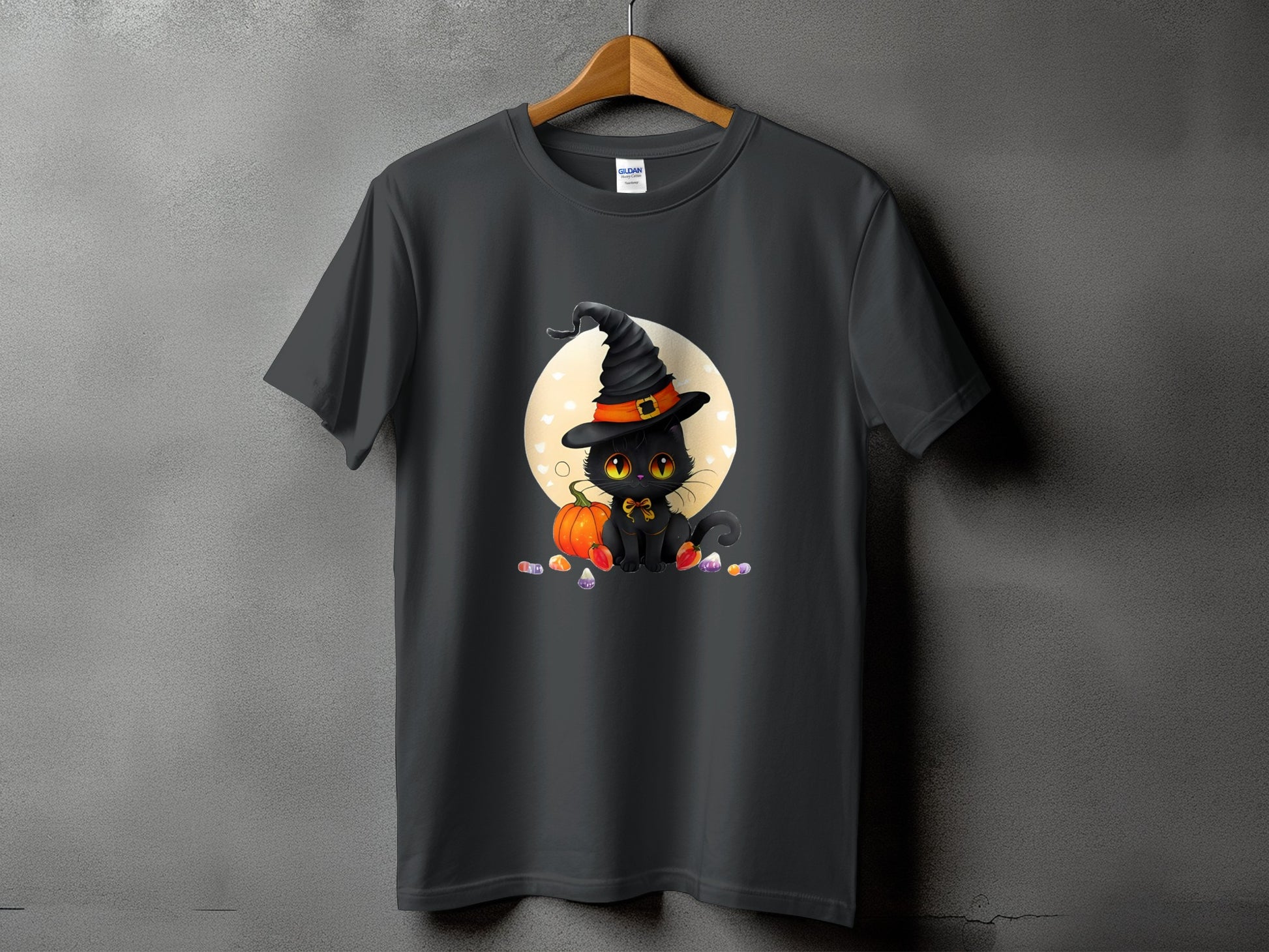 Black cat in witch hat with pumpkin and candy corn on a dark gray t-shirt.