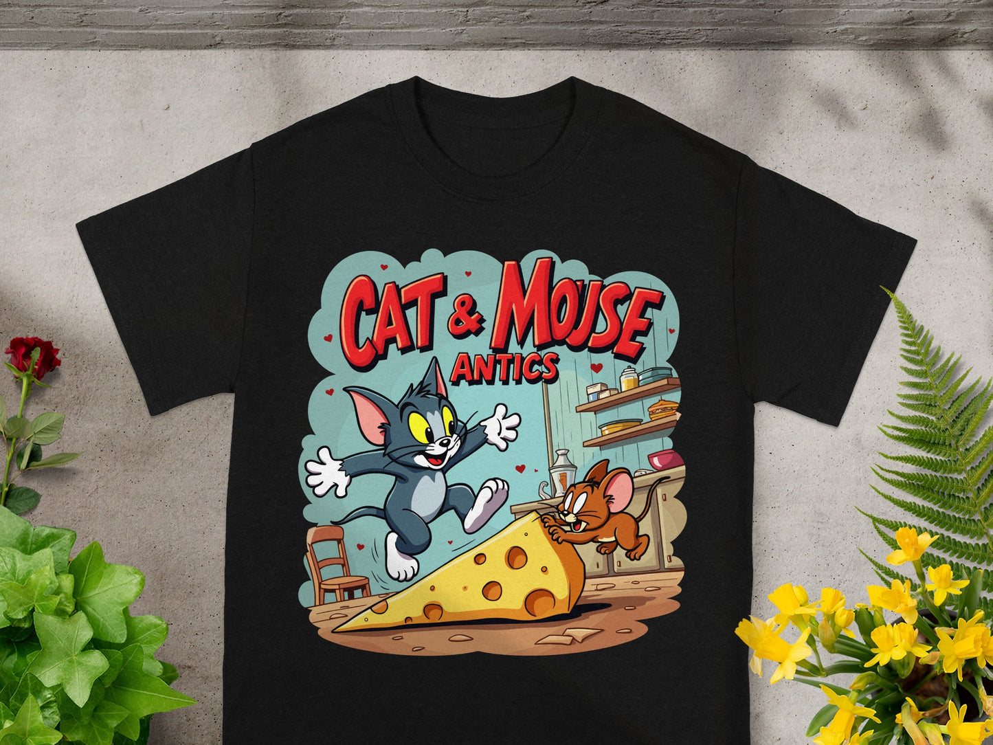 Black t-shirt with Cat & Mouse Antics graphic featuring Tom chasing Jerry on a giant cheese slice.