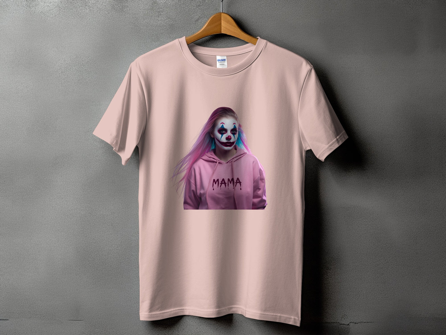 Light pink t-shirt with a graphic of a person in clown makeup and pink hair saying "mama".