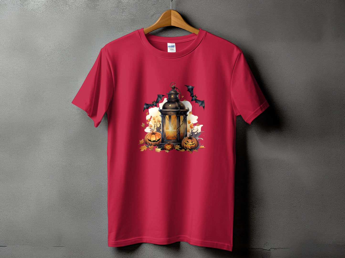 Red t-shirt with Halloween graphic of lantern, pumpkins, bats, and autumn leaves.