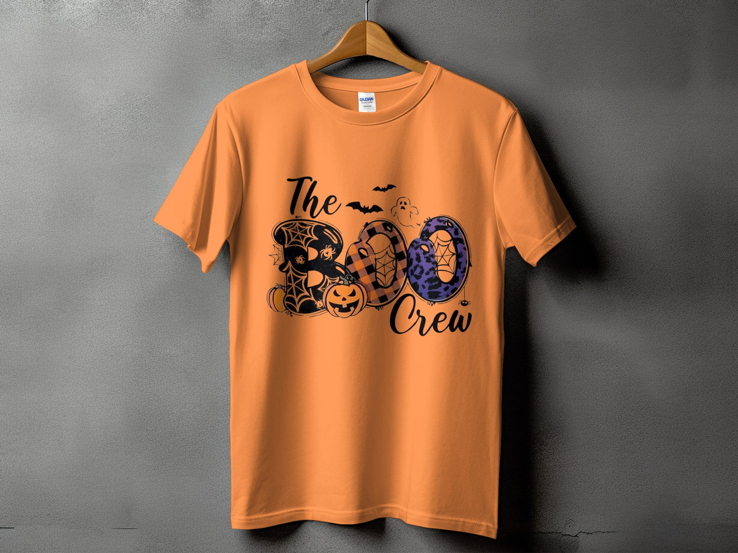 Orange t-shirt with "The Boo Crew" Halloween graphic featuring pumpkins and spiders.