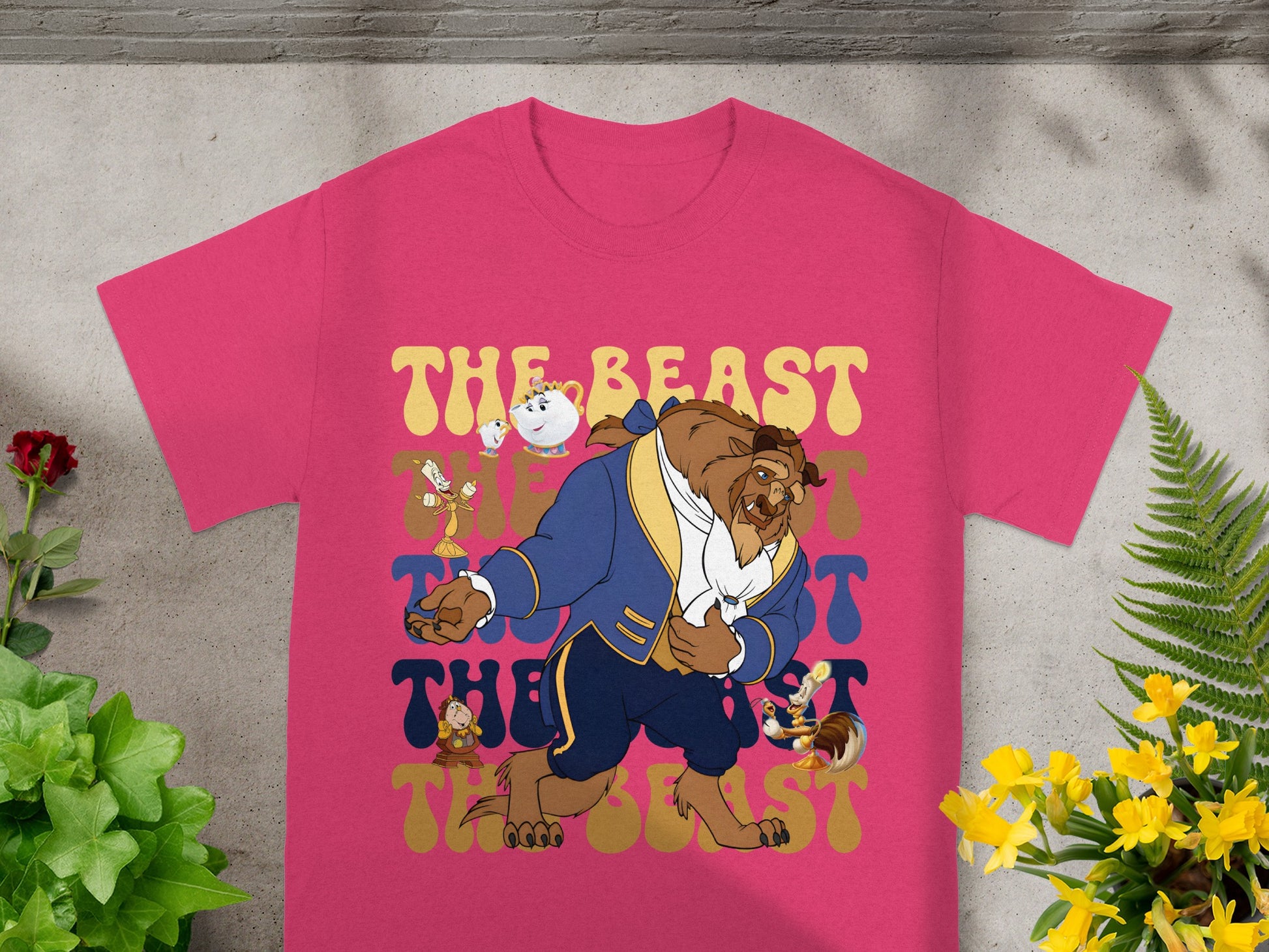 Beast and Chip dancing on a pink t-shirt with floral and plant accents.