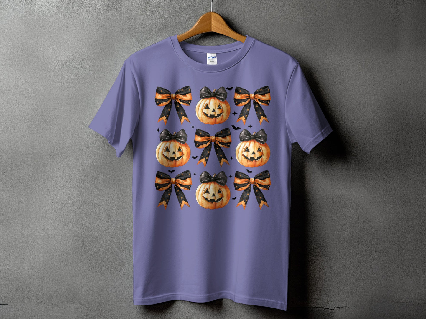 Purple t-shirt with a repeating pattern of jack-o'-lanterns and Halloween bows.