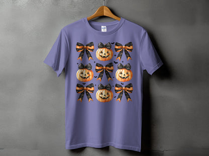 Purple t-shirt with a repeating pattern of jack-o'-lanterns and Halloween bows.
