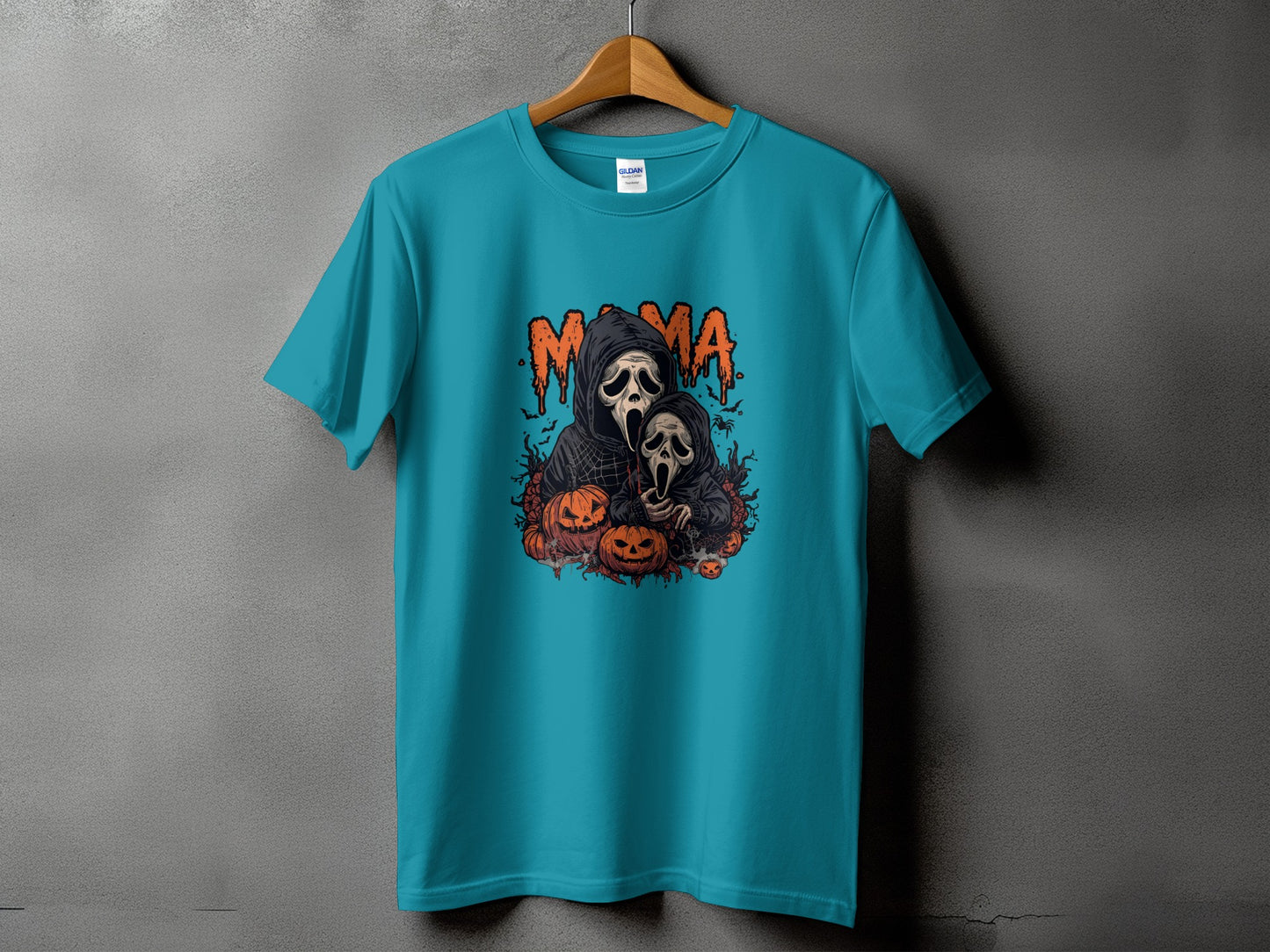 Teal t-shirt with "Mama" and spooky characters, pumpkins, and bats graphic.