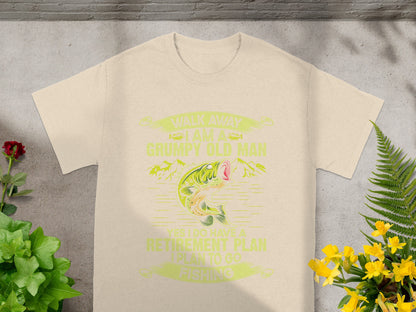 Cream t-shirt with graphic saying "Walk away I am a grumpy old man, yes I do have a retirement plan, I plan to go fishing."