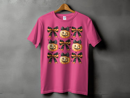 Pink t-shirt with a repeating pattern of Halloween pumpkins and black and orange bows.
