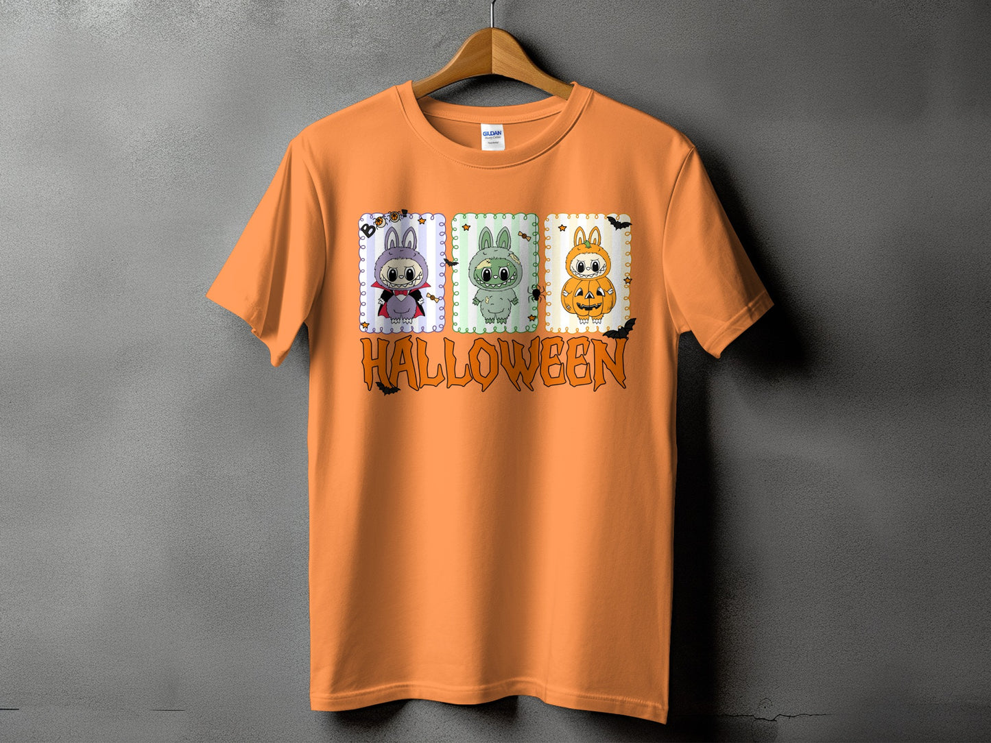Orange t-shirt with Halloween graphic featuring three cartoon bunnies and the word HALLOWEEN.