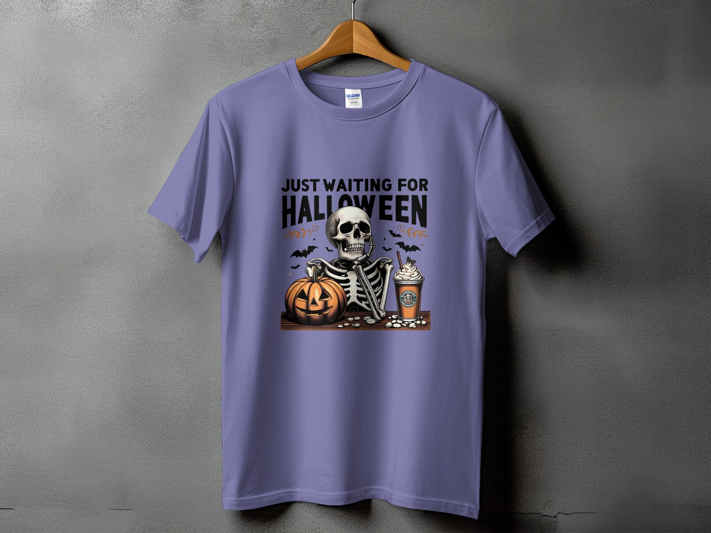 Purple t-shirt with skeleton, pumpkin, and coffee graphic, reads "Just Waiting for Halloween".