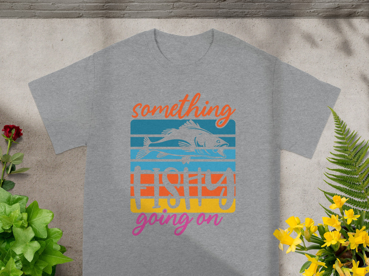 Grey t-shirt with "something fishy going on" text and a fish graphic.