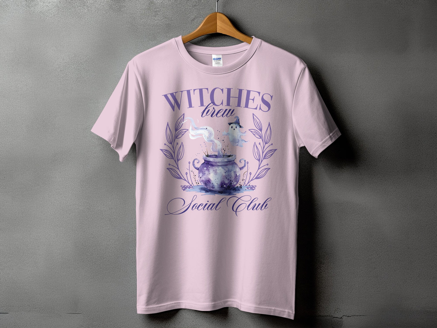 Lilac t-shirt with "Witches Brew Social Club" Halloween graphic.
