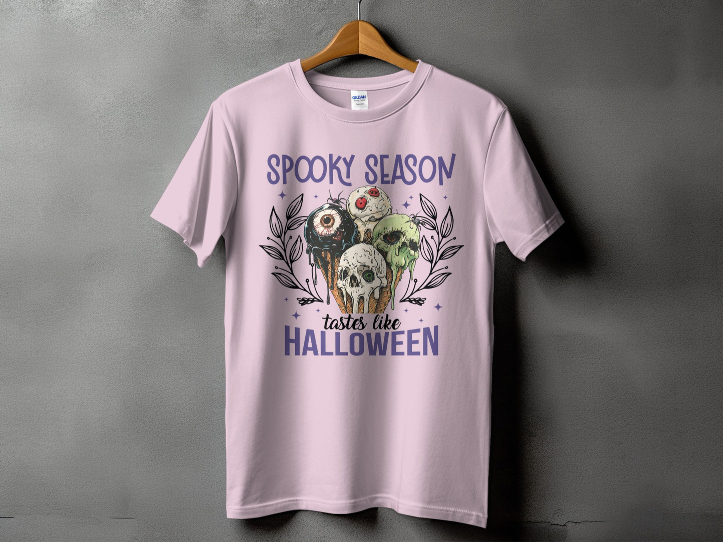 Pink t-shirt with "Spooky Season tastes like Halloween" text and spooky ice cream cones.