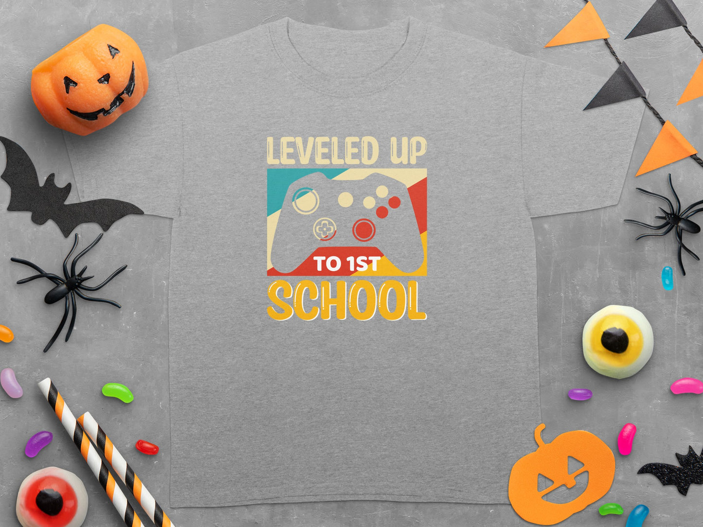 Grey t-shirt with "LEVELED UP TO 1ST SCHOOL" and a video game controller graphic.