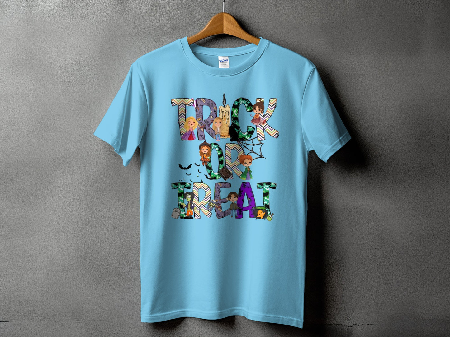 Light blue t-shirt with "Trick or Treat" Halloween graphic featuring cartoon characters and pumpkins.