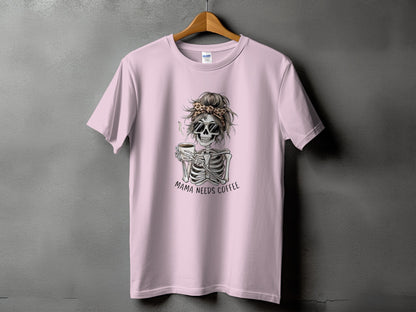 Pink t-shirt with skeleton graphic holding coffee and text "Mama Needs Coffee".