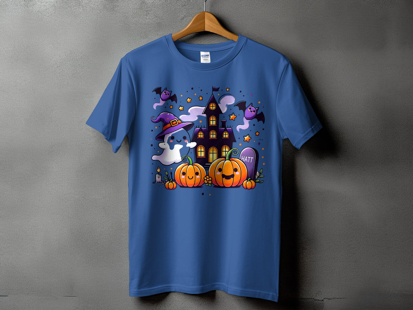 Blue t-shirt with a cute Halloween design featuring pumpkins, ghosts, bats, and a haunted house.
