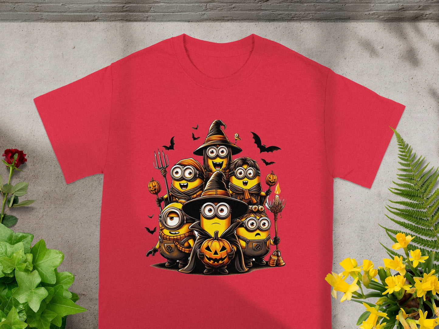 Red t-shirt features Minions in Halloween costumes holding pumpkins and candy.