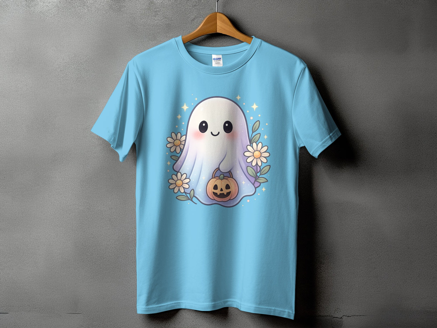 Light blue t-shirt with a cute ghost holding a pumpkin surrounded by flowers.