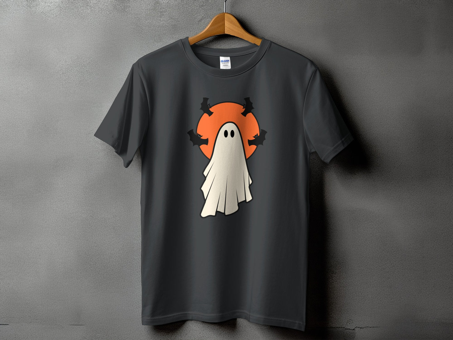 Dark t-shirt with a white ghost and bats design on an orange circle.