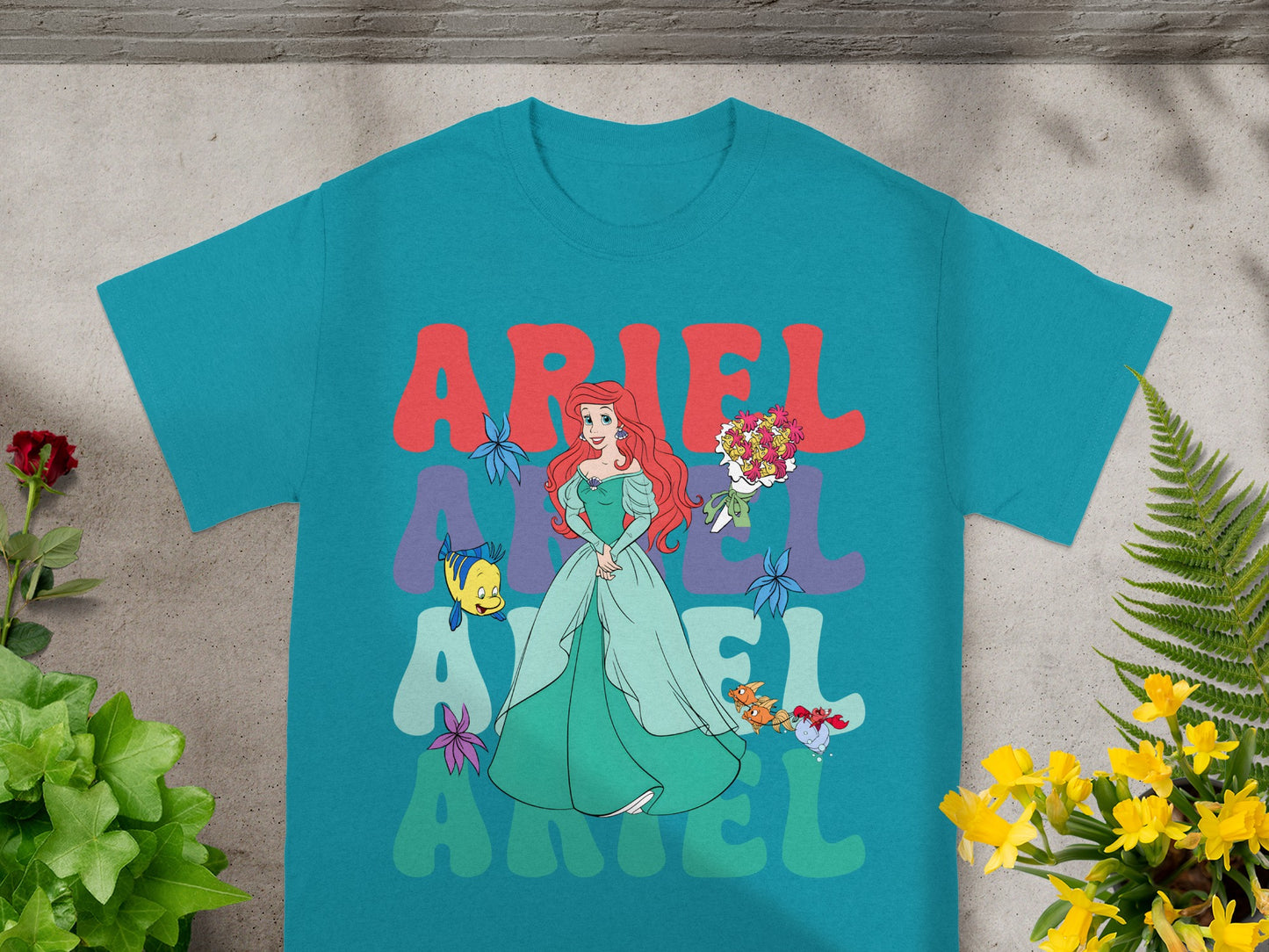 Teal t-shirt with Ariel from The Little Mermaid and her name in large letters.