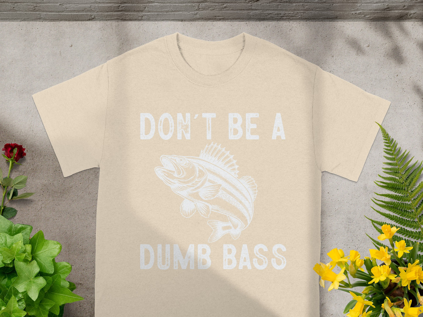 T-shirt with text "DON'T BE A DUMB BASS" and a fish graphic.