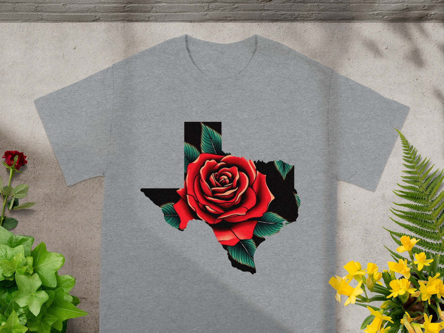 Grey t-shirt with Texas shape filled by a red rose and green leaves.