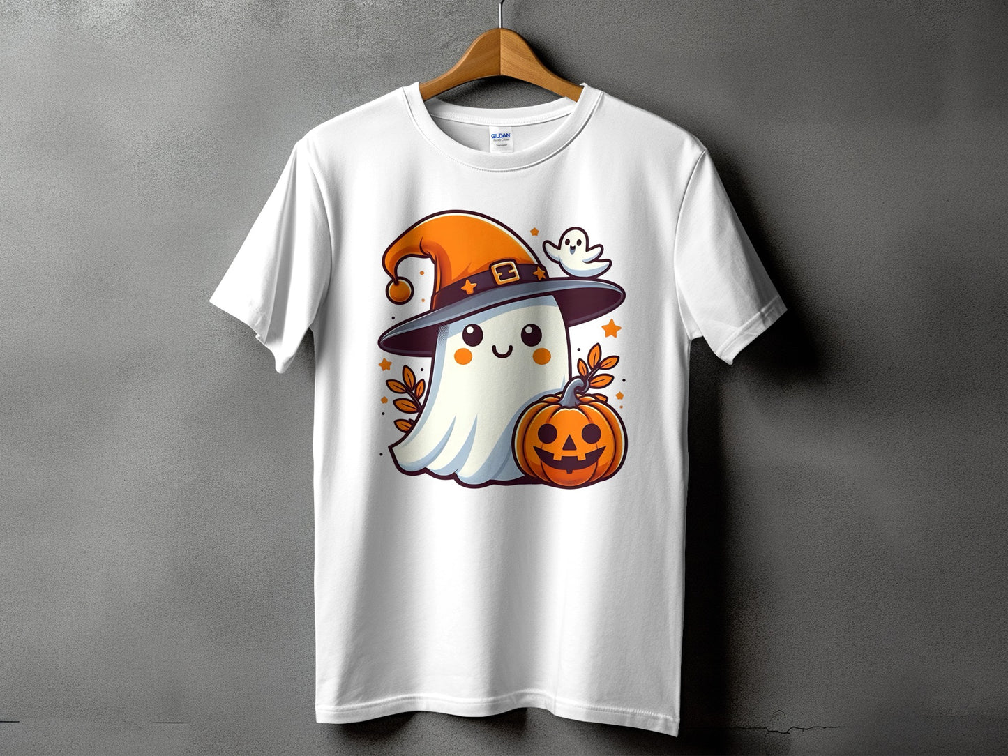 White t-shirt with a cartoon ghost wearing a witch hat and holding a jack-o'-lantern.