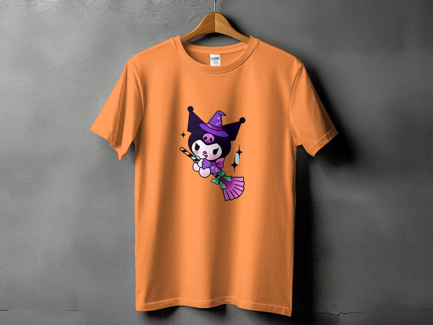 Orange t-shirt with Kuromi wearing a witch hat, flying on a broomstick.