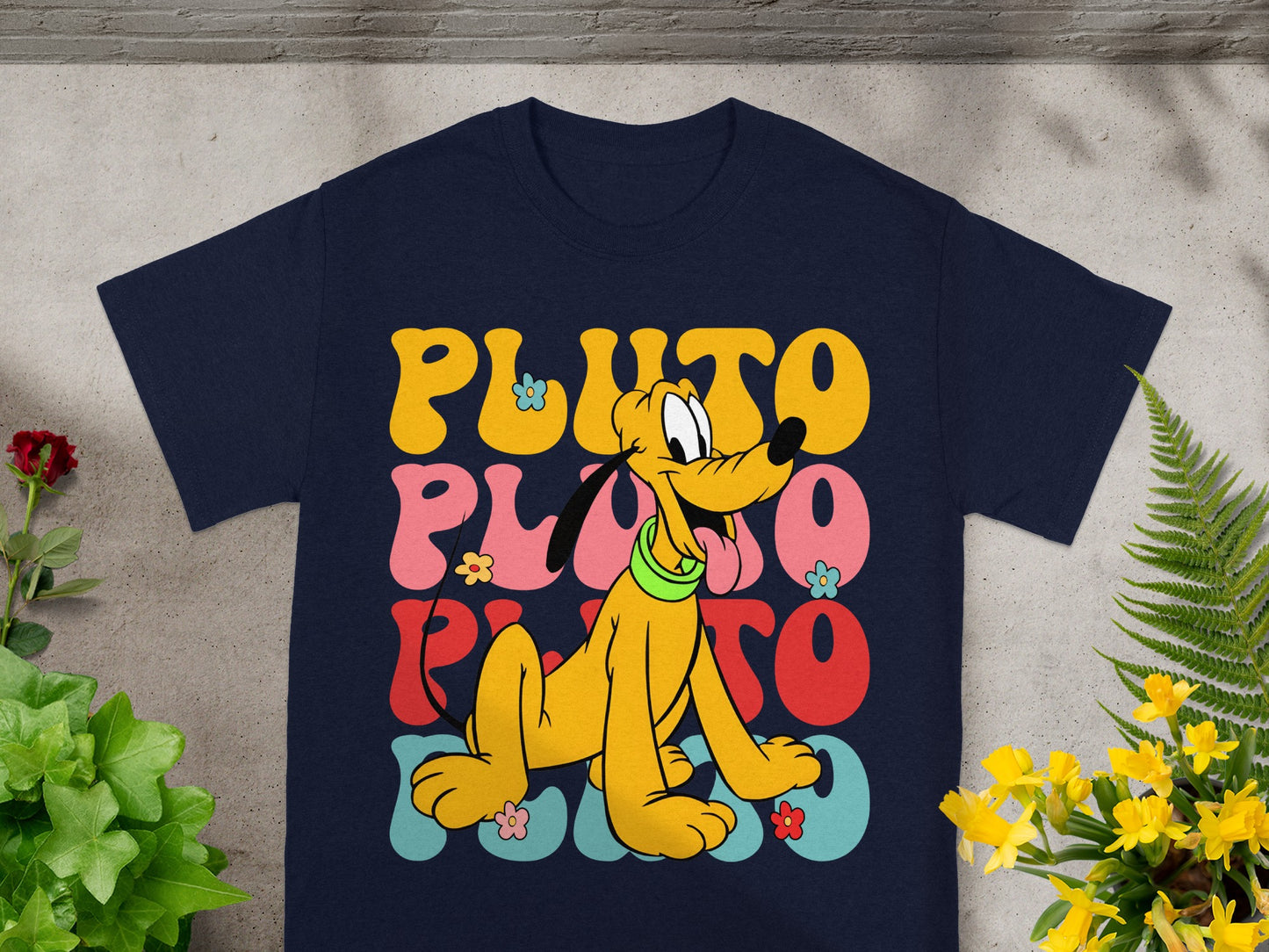 Navy t-shirt with Pluto and wavy "PLUTO" text in retro colors.