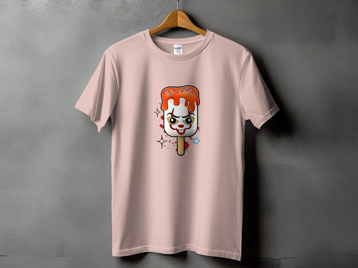 Pink t-shirt with a creepy clown ice pop graphic and splatters.