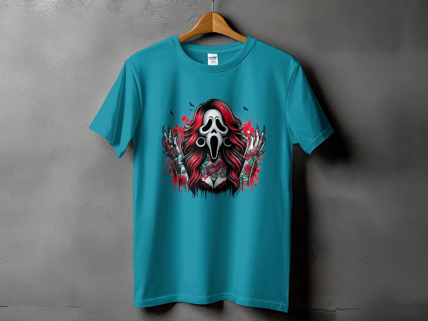 Teal t-shirt with a screaming ghost mask and tattooed figure graphic.