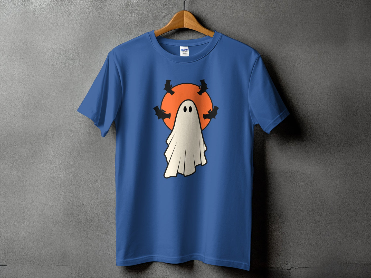 Blue t-shirt with a white ghost and bats in front of an orange circle.