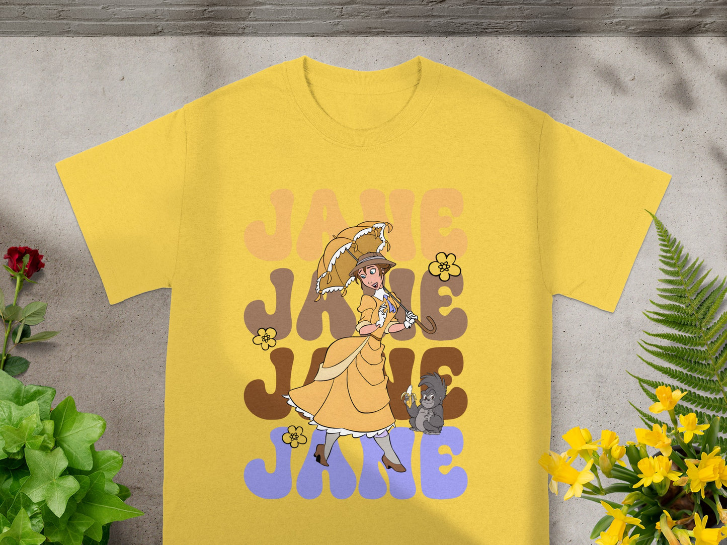 Yellow t-shirt with "JANE JANE" text and a woman with an umbrella.