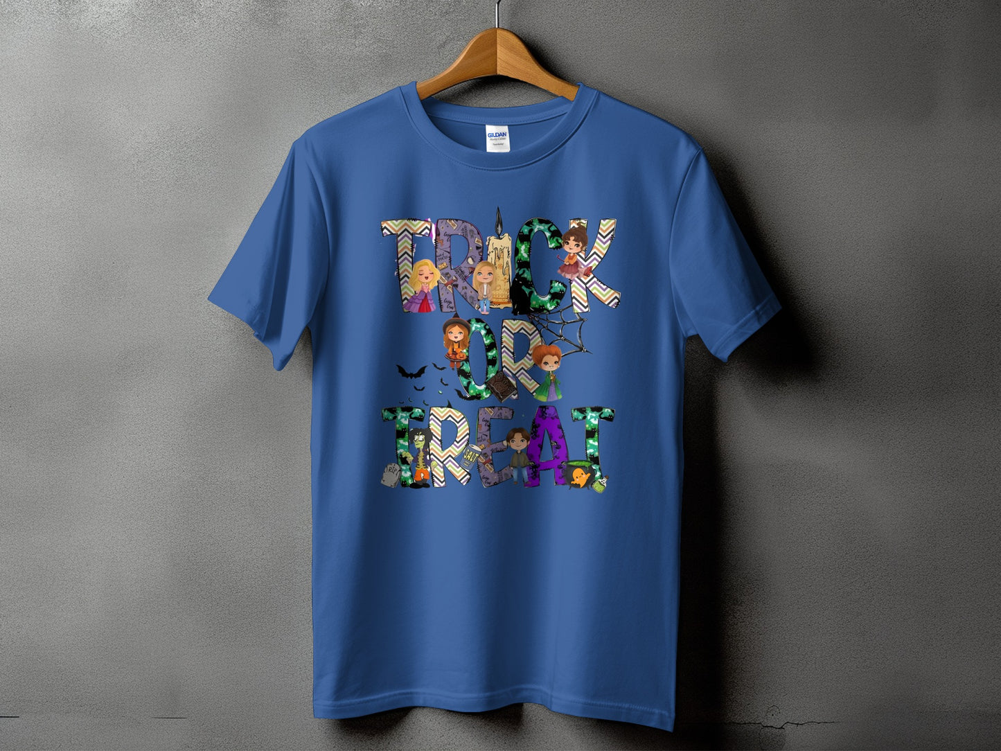 Blue t-shirt with "Trick or Treat" text featuring cartoon characters and Halloween motifs.