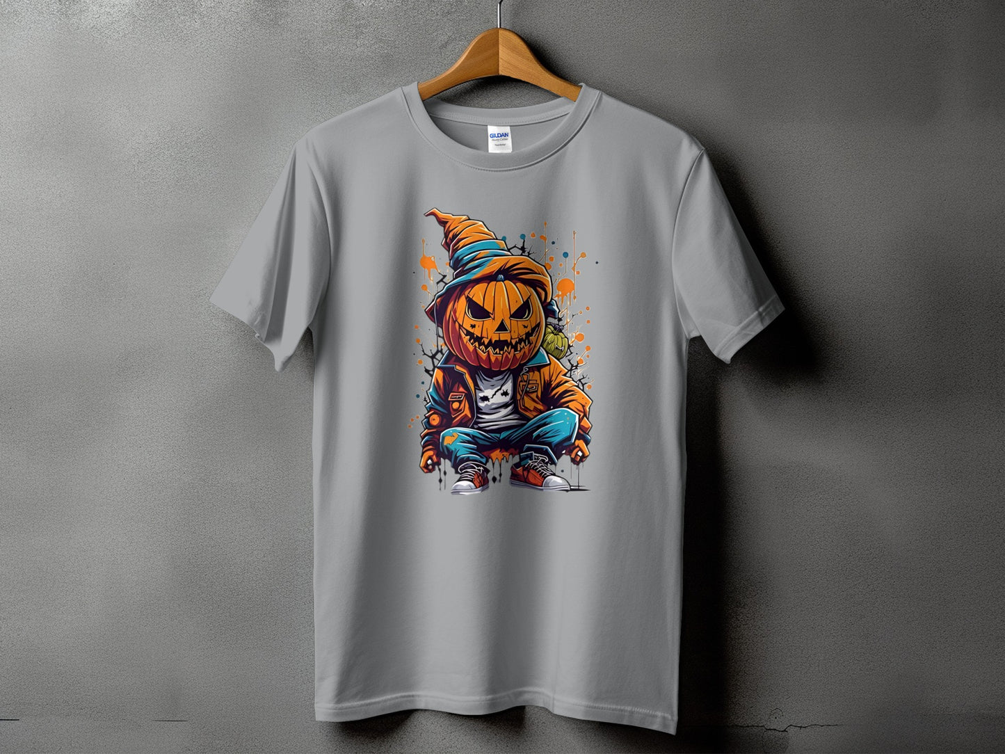 T-shirt with graphic of a pumpkin character in a hat and jacket, squatting.